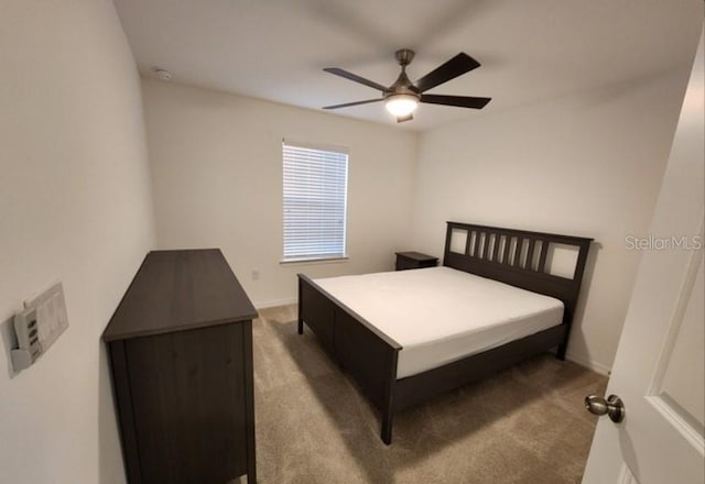 bedroom featuring light carpet and ceiling fan