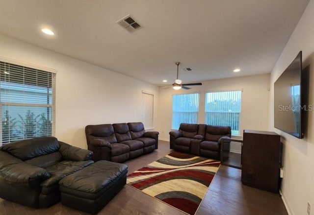 living room featuring dark hardwood / wood-style floors and ceiling fan