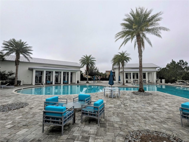 pool with a patio area and an outdoor living space