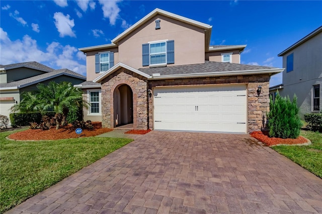 view of front facade with a garage, stone siding, stucco siding, decorative driveway, and a front yard