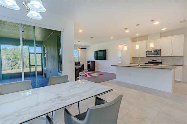 dining room with ceiling fan and recessed lighting