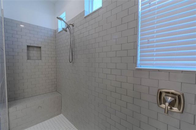 full bath featuring a tile shower