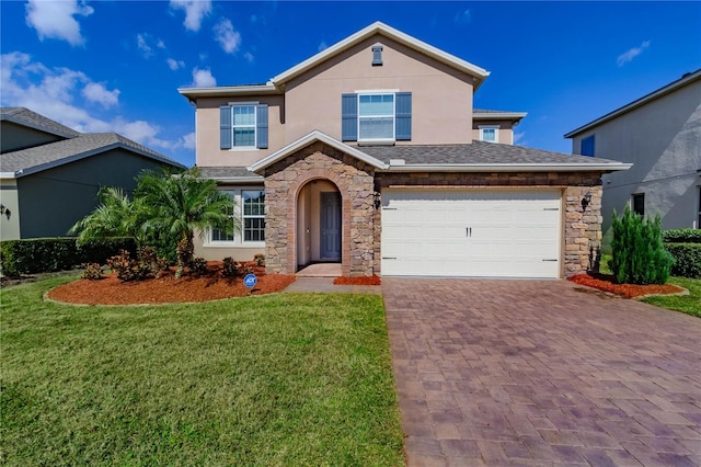 traditional home with a garage, stone siding, stucco siding, decorative driveway, and a front yard