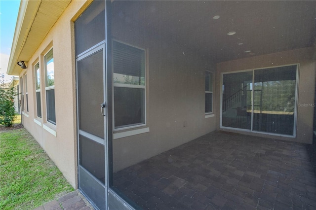 exterior space featuring a patio area and stucco siding