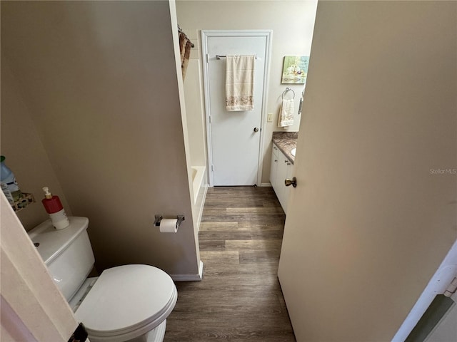 bathroom featuring vanity, hardwood / wood-style floors, and toilet