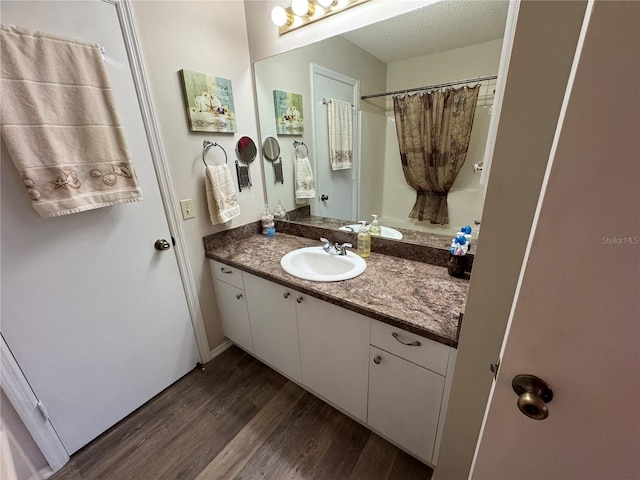 bathroom with vanity, hardwood / wood-style floors, and a textured ceiling