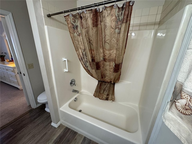 bathroom with wood-type flooring, toilet, and shower / bath combo with shower curtain