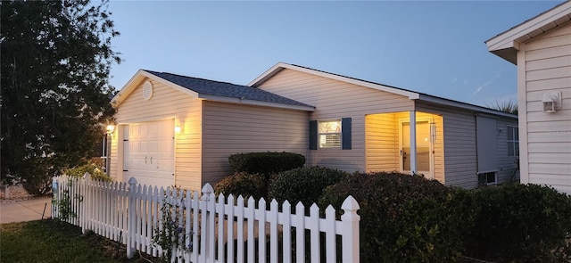 view of side of property with a garage