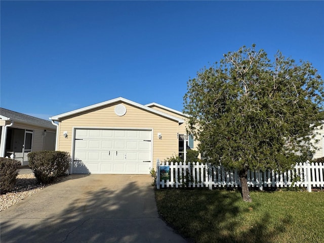 482 Hildalgo Dr, The Villages, FL 32159 - view of front of house featuring fence, driveway, and a garage