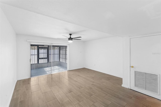 spare room with ceiling fan and wood-type flooring