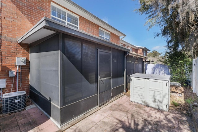 view of property exterior with a sunroom and central AC unit