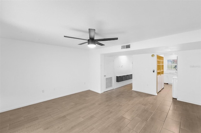 unfurnished living room featuring ceiling fan and light wood-type flooring