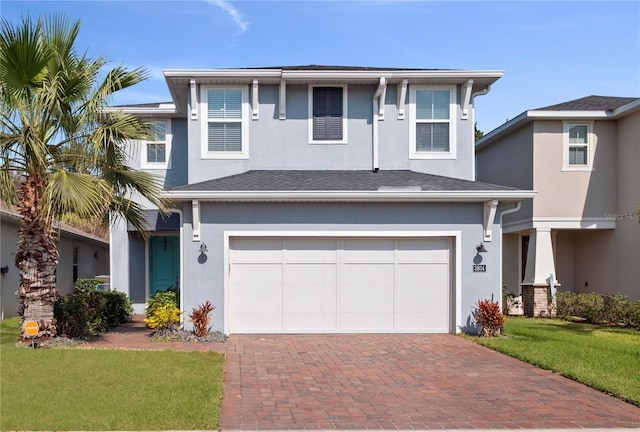 view of front of house featuring a garage and a front lawn