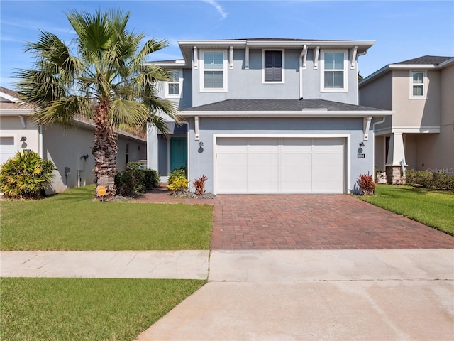 view of front facade featuring a garage and a front lawn