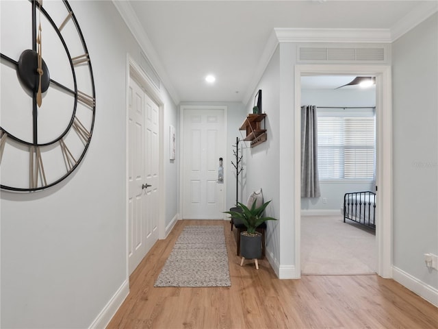 interior space with ornamental molding and light wood-type flooring