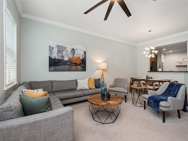 living room featuring crown molding, ceiling fan with notable chandelier, light carpet, and a wealth of natural light