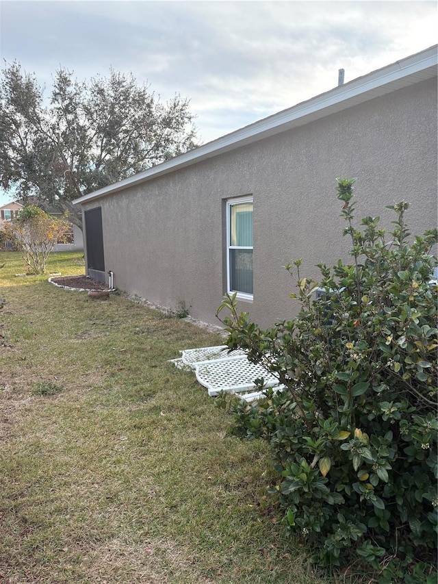 view of home's exterior with a lawn