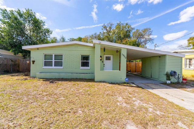 ranch-style house with a carport and a front yard