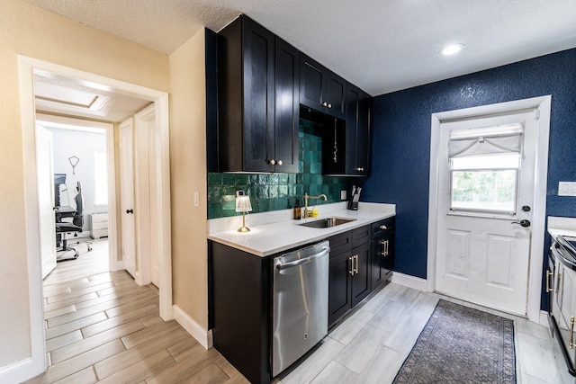 kitchen featuring electric stove, sink, tasteful backsplash, a textured ceiling, and stainless steel dishwasher