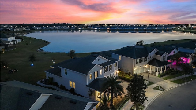 aerial view at dusk with a water view