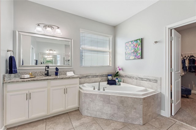 4608 Egg Harbor Dr, Kissimmee, FL 34746 - bathroom with vanity, tile patterned flooring, and tiled bath