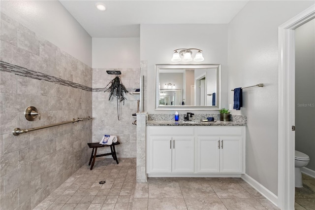 4608 Egg Harbor Dr, Kissimmee, FL 34746 - bathroom featuring a tile shower, vanity, tile patterned flooring, and toilet