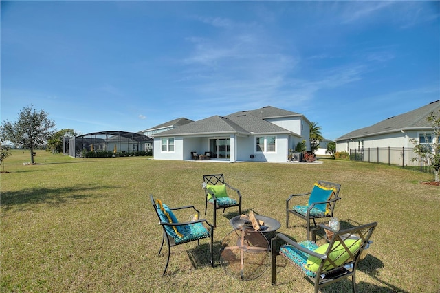 4608 Egg Harbor Dr, Kissimmee, FL 34746 - rear view of house with a yard and glass enclosure