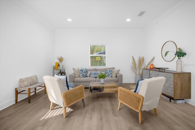 living area with crown molding and light wood-type flooring