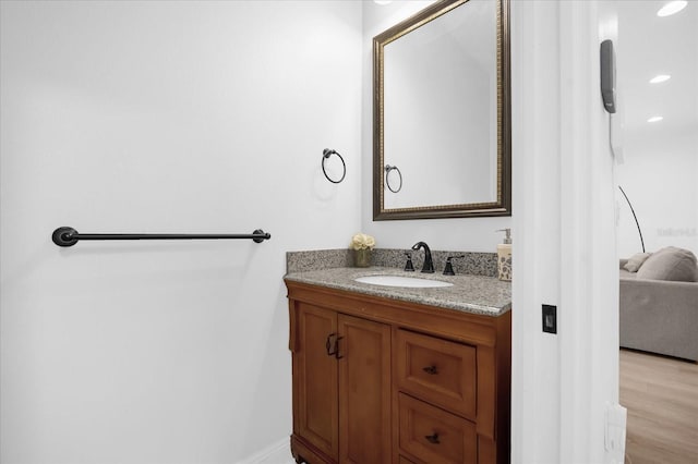 bathroom with vanity and wood-type flooring