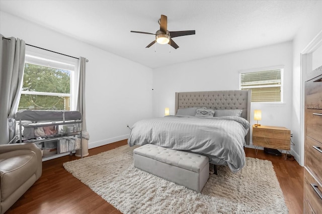 bedroom with ceiling fan and dark hardwood / wood-style flooring