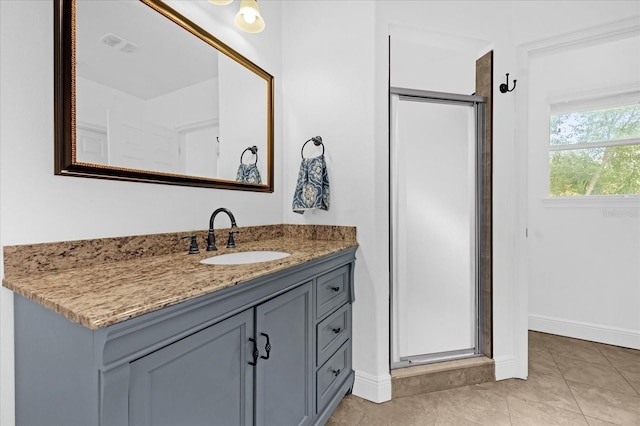 bathroom featuring vanity, an enclosed shower, and tile patterned floors