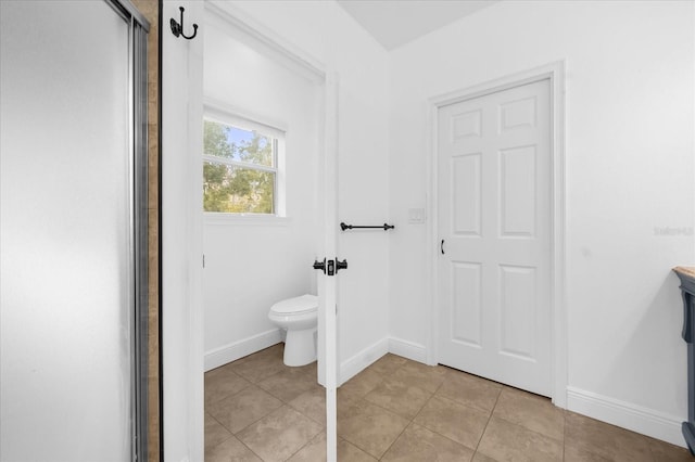 bathroom with tile patterned floors and toilet