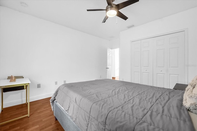 bedroom with wood-type flooring, a closet, and ceiling fan