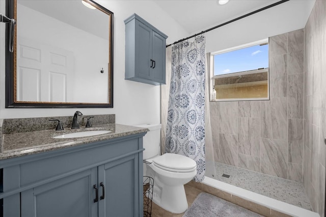 bathroom with vanity, curtained shower, and toilet