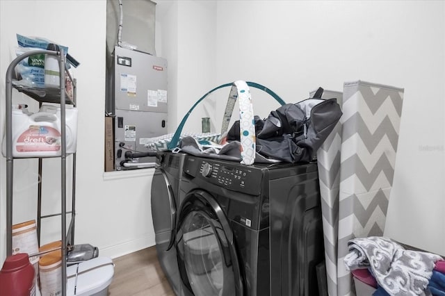 washroom with wood-type flooring and separate washer and dryer