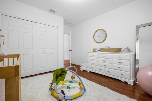 bedroom featuring dark hardwood / wood-style flooring and a closet