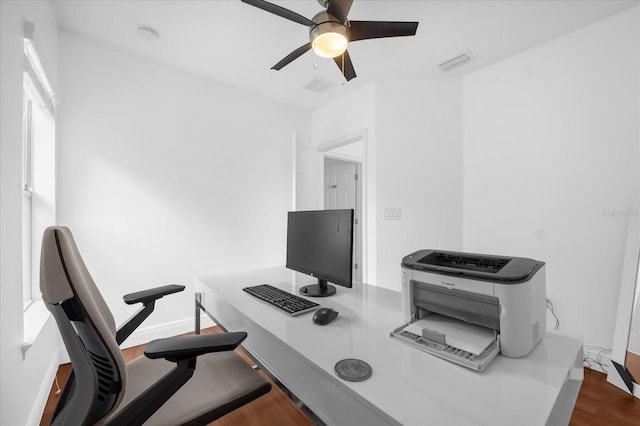 home office with wood-type flooring and ceiling fan