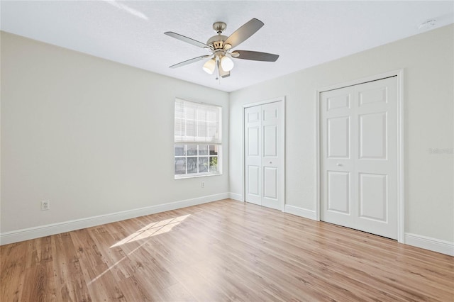 unfurnished bedroom featuring a ceiling fan, baseboards, and light wood finished floors