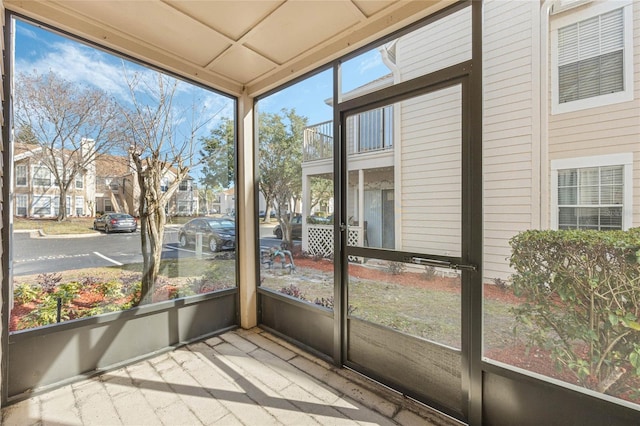 unfurnished sunroom with a residential view