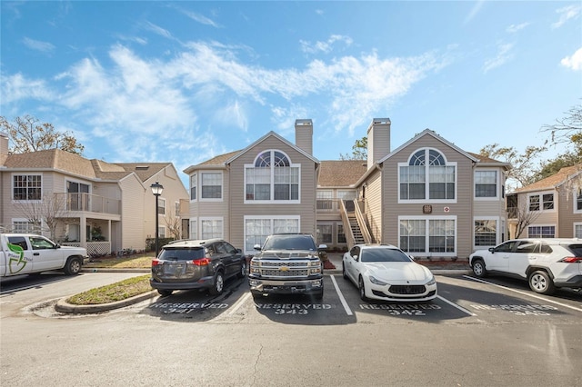 exterior space with uncovered parking and stairway