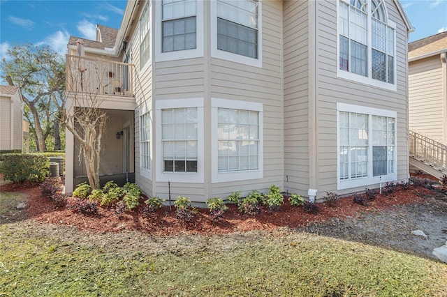 view of side of property featuring central AC