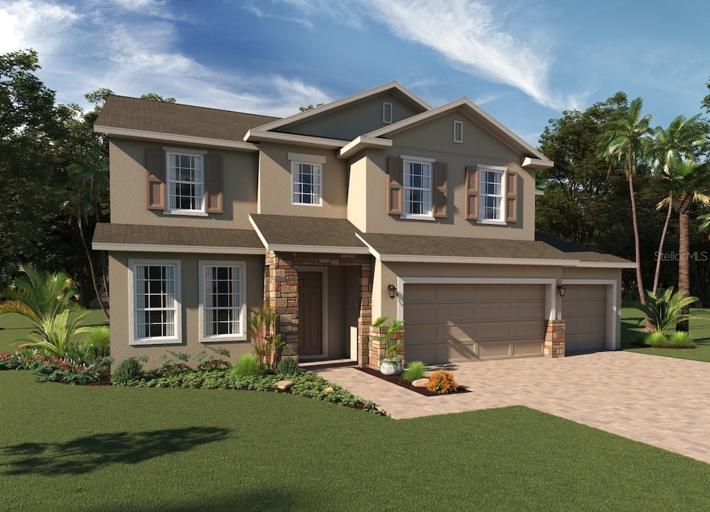 view of front of property with a garage and a front yard