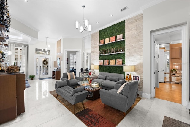 living room featuring an inviting chandelier, a towering ceiling, and ornamental molding