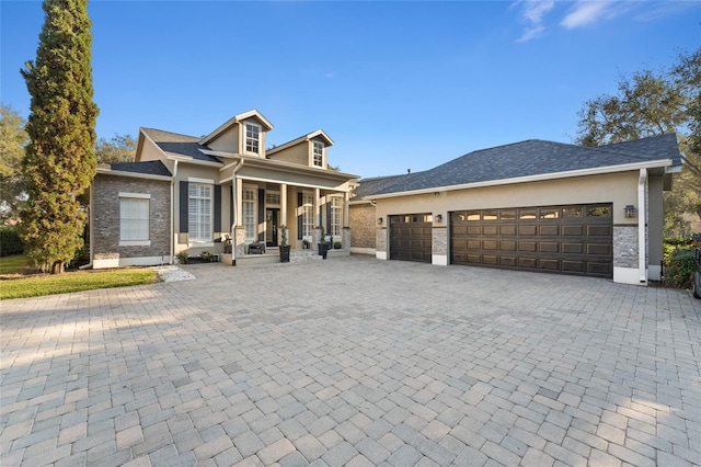 view of front of house featuring a porch and a garage