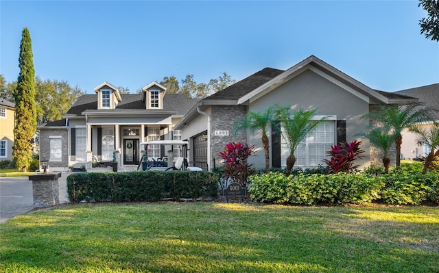 view of front of property featuring a garage and a front yard