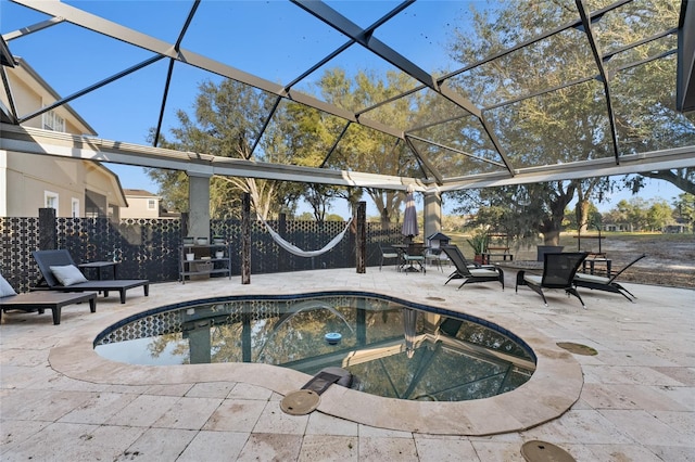 view of swimming pool with a patio and a lanai