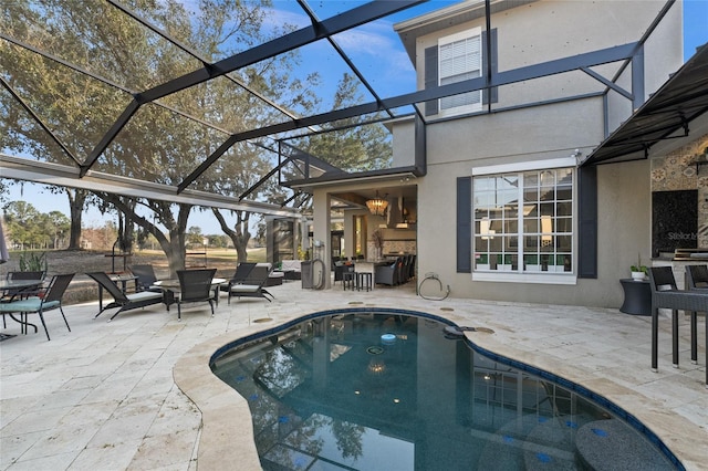 view of swimming pool featuring a patio area and glass enclosure