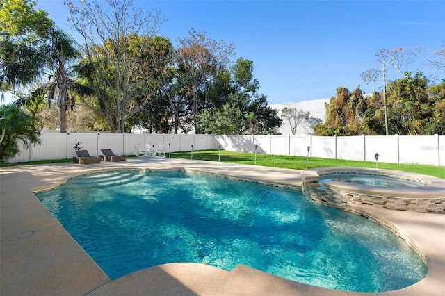 view of swimming pool featuring an in ground hot tub and a patio