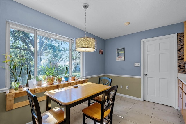 dining area featuring light tile patterned flooring