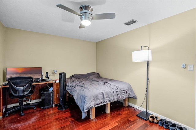 bedroom featuring dark hardwood / wood-style flooring and ceiling fan